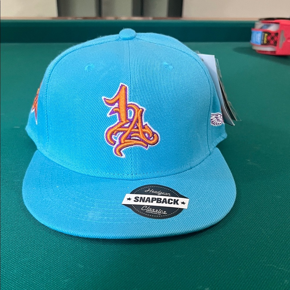 Koby Bryant Light Blue Snapback Hat with Orange LA Logo